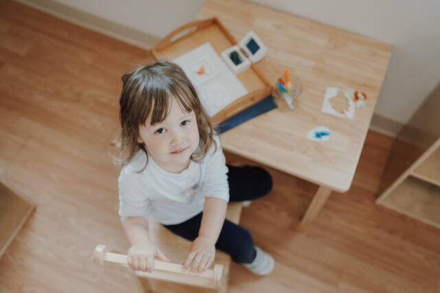 Carrying a stool across the classroom