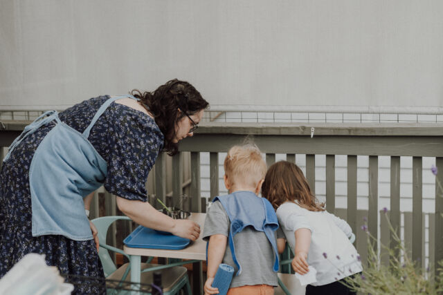 A guide and toddlers look out over the deck rail