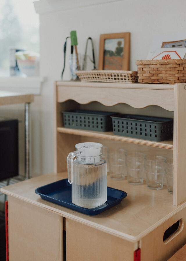 A pitcher and glasses ready on the shelf