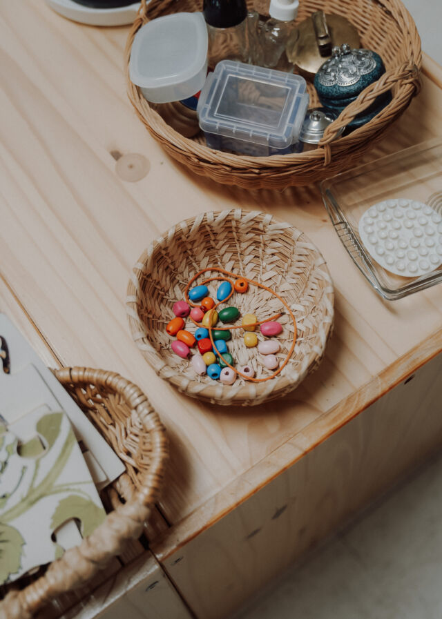 A basket of beads on the classroom shelf