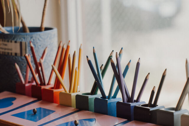 Colored pencils in their rainbow holders