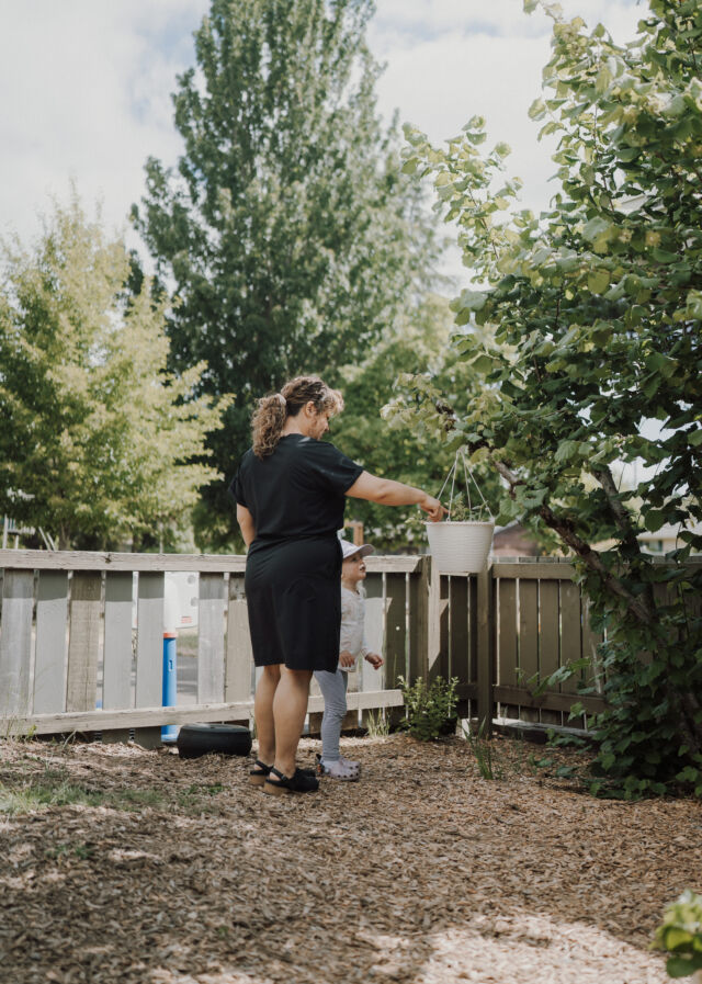 A guide tends the garden fence line