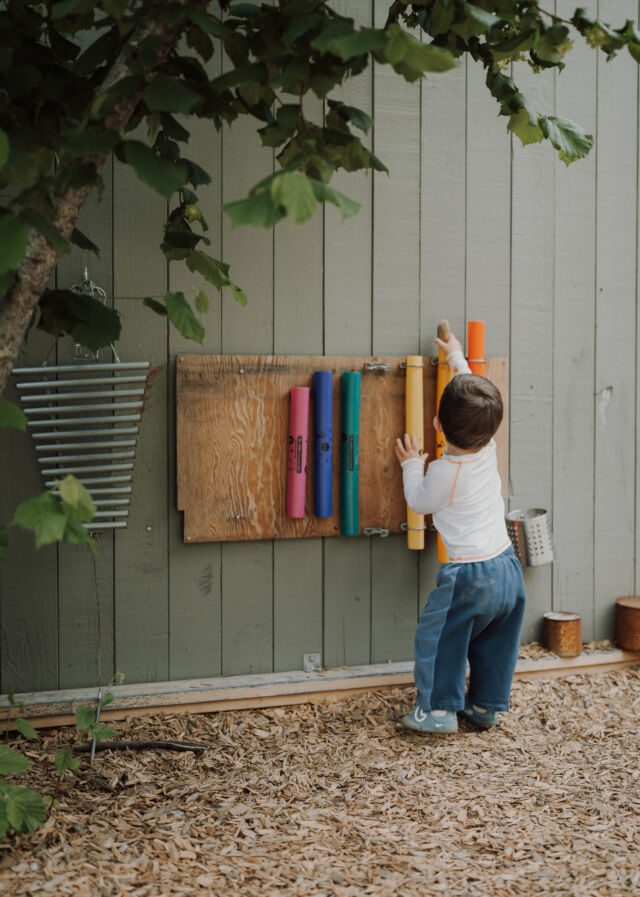 Playing the chime wall in the garden