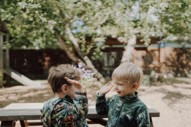 Two friends laughing at the picnic table