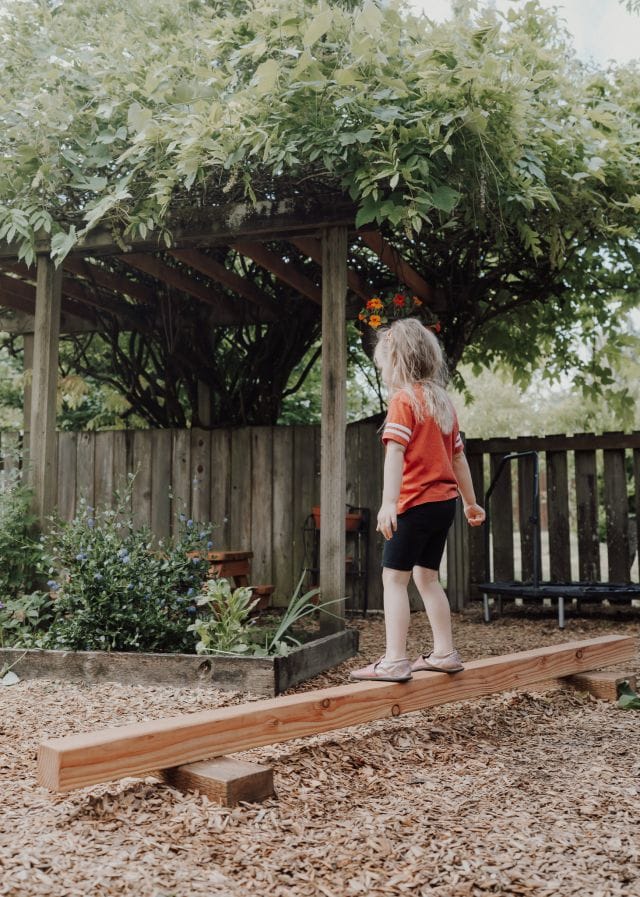 Walking the balance beam under the pergola