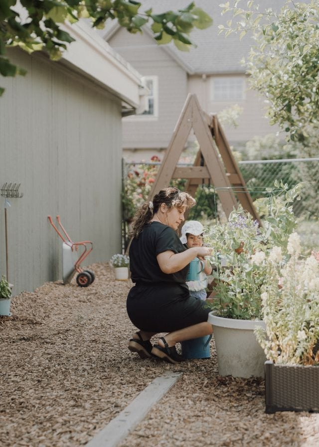 A guide tends the flower planters in the garden
