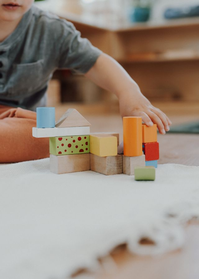 Small hands stacking blocks