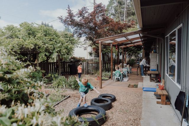 The covered deck and garden walkway outside the classrooms